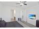 Bedroom with a ceiling fan and a view to the bathroom and hallway at 2587 Summer Star Way, Leesburg, FL 34748