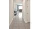 Bright hallway featuring tile flooring and views into the dining and living areas at 2587 Summer Star Way, Leesburg, FL 34748