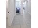 Bright hallway featuring tile flooring and leading to various rooms at 2587 Summer Star Way, Leesburg, FL 34748