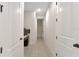 Neutral hallway boasting tile floors and crisp white doors at 2587 Summer Star Way, Leesburg, FL 34748