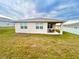 Backyard view of house with patio and yard at 2587 Summer Star Way, Leesburg, FL 34748