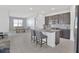 Bright eat-in kitchen featuring gray cabinetry, stainless appliances, and a large kitchen island at 2587 Summer Star Way, Leesburg, FL 34748