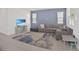 Welcoming living room featuring a comfortable gray sofa and an area rug at 2587 Summer Star Way, Leesburg, FL 34748