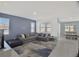 Open living room with comfortable gray seating and tile flooring at 2587 Summer Star Way, Leesburg, FL 34748