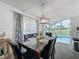 Dining area with a marble table, six chairs, and a view of the pool at 2948 Kokomo Loop, Haines City, FL 33844