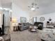 Comfortable living room with gray sofas, a coffee table, and a ceiling fan at 2948 Kokomo Loop, Haines City, FL 33844