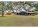 Large backyard with mature trees, shed, and screened patio at 3251 Pinewood Ct, Kissimmee, FL 34746