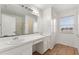 Clean bathroom with double vanity, tiled floor, and a window at 3610 Old Berkley Rd, Auburndale, FL 33823