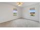 Bedroom with two windows, ceiling fan, and carpet at 3610 Old Berkley Rd, Auburndale, FL 33823