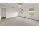 Spacious bedroom with carpeted floors and two windows at 3610 Old Berkley Rd, Auburndale, FL 33823