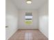 Simple bedroom with tiled floors and a window offering natural light at 3610 Old Berkley Rd, Auburndale, FL 33823
