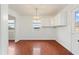 A bright dining area with wood flooring and a view into the kitchen and living room at 3610 Old Berkley Rd, Auburndale, FL 33823