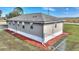 Tan home with red mulch and a chain link fence at 3610 Old Berkley Rd, Auburndale, FL 33823