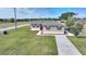 Single story home with grey siding and a long driveway at 3610 Old Berkley Rd, Auburndale, FL 33823