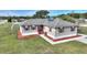 Single-story house with grey siding, red accents, and a large yard at 3610 Old Berkley Rd, Auburndale, FL 33823