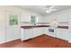 White kitchen cabinets, dishwasher, and an electric range at 3610 Old Berkley Rd, Auburndale, FL 33823