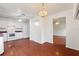 Bright kitchen features white cabinetry, wood flooring, and a view into the adjacent dining area at 3610 Old Berkley Rd, Auburndale, FL 33823