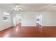 Open concept living room with wood floors and views of the kitchen at 3610 Old Berkley Rd, Auburndale, FL 33823