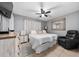 Comfortable bedroom with a ceiling fan, tile flooring, dresser, and a chair, perfect for relaxation at 3618 Willow Lake Ct, St Cloud, FL 34769