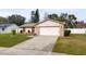 One-story house with a pink garage door and nicely landscaped yard at 3618 Willow Lake Ct, St Cloud, FL 34769