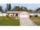 Single story house with pink garage door and stone accents at 3618 Willow Lake Ct, St Cloud, FL 34769