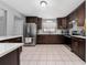 Modern kitchen with stainless steel appliances, dark cabinets, and ample countertop space for meal preparation at 3618 Willow Lake Ct, St Cloud, FL 34769