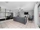 Spacious living room with tile floors, light grey paint, modern ceiling fan and large wall mirror at 3618 Willow Lake Ct, St Cloud, FL 34769