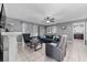 Living room with gray sofas, a fireplace, and tiled floors at 3618 Willow Lake Ct, St Cloud, FL 34769