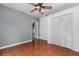 Versatile room with neutral walls, ceiling fan, wood flooring, and a closet at 3618 Willow Lake Ct, St Cloud, FL 34769