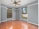 Bright room with hardwood floors and multiple windows, perfect for a living area or office space at 3618 Willow Lake Ct, St Cloud, FL 34769