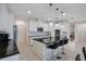 Modern kitchen with white cabinets, granite island, and pendant lighting at 3865 Prairie Reserve Blvd, Orlando, FL 32824