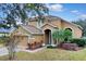 Two-story house with a two-car garage and landscaped front yard at 4364 Fox Glen Loop, Kissimmee, FL 34746