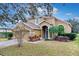 Two-story house with a two-car garage and palm trees in the front at 4364 Fox Glen Loop, Kissimmee, FL 34746