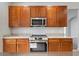 Kitchen boasting stainless steel appliances and wood cabinets at 4364 Fox Glen Loop, Kissimmee, FL 34746