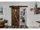 Rustic barn door leading to living area at 540 E 19Th St, St Cloud, FL 34769