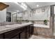 Elegant bathroom with double sinks, soaking tub, and walk-in shower at 540 E 19Th St, St Cloud, FL 34769