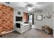 Bedroom with brick accent wall, daybed, and ceiling fan at 540 E 19Th St, St Cloud, FL 34769