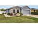 Close-up view of the home's exterior and lush front lawn with decorative seating at 540 E 19Th St, St Cloud, FL 34769