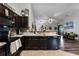 Modern kitchen with dark cabinets, stainless steel appliances, and a farmhouse sink at 540 E 19Th St, St Cloud, FL 34769