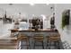 Kitchen island with seating, dark cabinetry, and stainless steel appliances at 540 E 19Th St, St Cloud, FL 34769