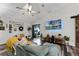 Living room with L-shaped sofa, large TV, and sliding glass doors to patio at 540 E 19Th St, St Cloud, FL 34769