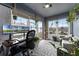 Sunroom with backyard view, workspace, and comfortable seating at 540 E 19Th St, St Cloud, FL 34769