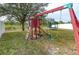 Playset and swings in grassy backyard at 5589 Sycamore Canyon Dr, Kissimmee, FL 34758