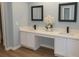 Modern bathroom with dual sinks, quartz countertops, sleek black faucets, and wood grain floors at 570 Bristol Cir, Kissimmee, FL 34758