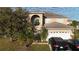 Two-story house with a large garage and mature landscaping at 570 Bristol Cir, Kissimmee, FL 34758