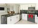 Modern kitchen with white cabinets, stainless steel appliances, and a black granite countertop with a double sink at 570 Bristol Cir, Kissimmee, FL 34758