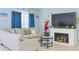 Cozy living room with a decorative fireplace, a comfortable couch, blue curtains, and soft, blue-painted walls at 570 Bristol Cir, Kissimmee, FL 34758