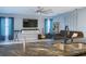 Inviting living room with blue walls, modern decor, a large television, and an open view from the kitchen sink at 570 Bristol Cir, Kissimmee, FL 34758