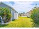 Spacious backyard with lush green lawn and mature trees, perfect for outdoor activities and relaxation at 6144 Forest Ridge Way, Winter Haven, FL 33881