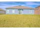 Well-maintained backyard featuring a large, grassy area and neutral exterior paint at 6144 Forest Ridge Way, Winter Haven, FL 33881